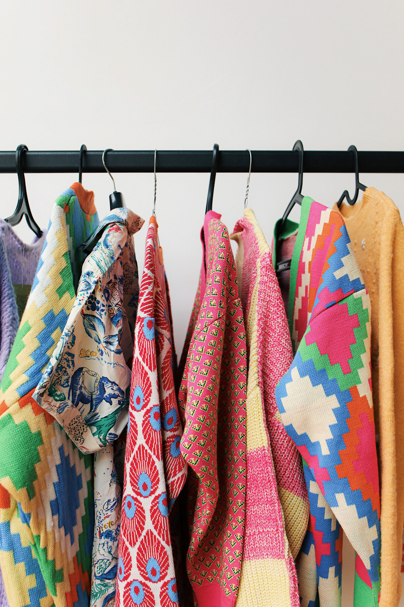 Sweaters Hanging on Rack 